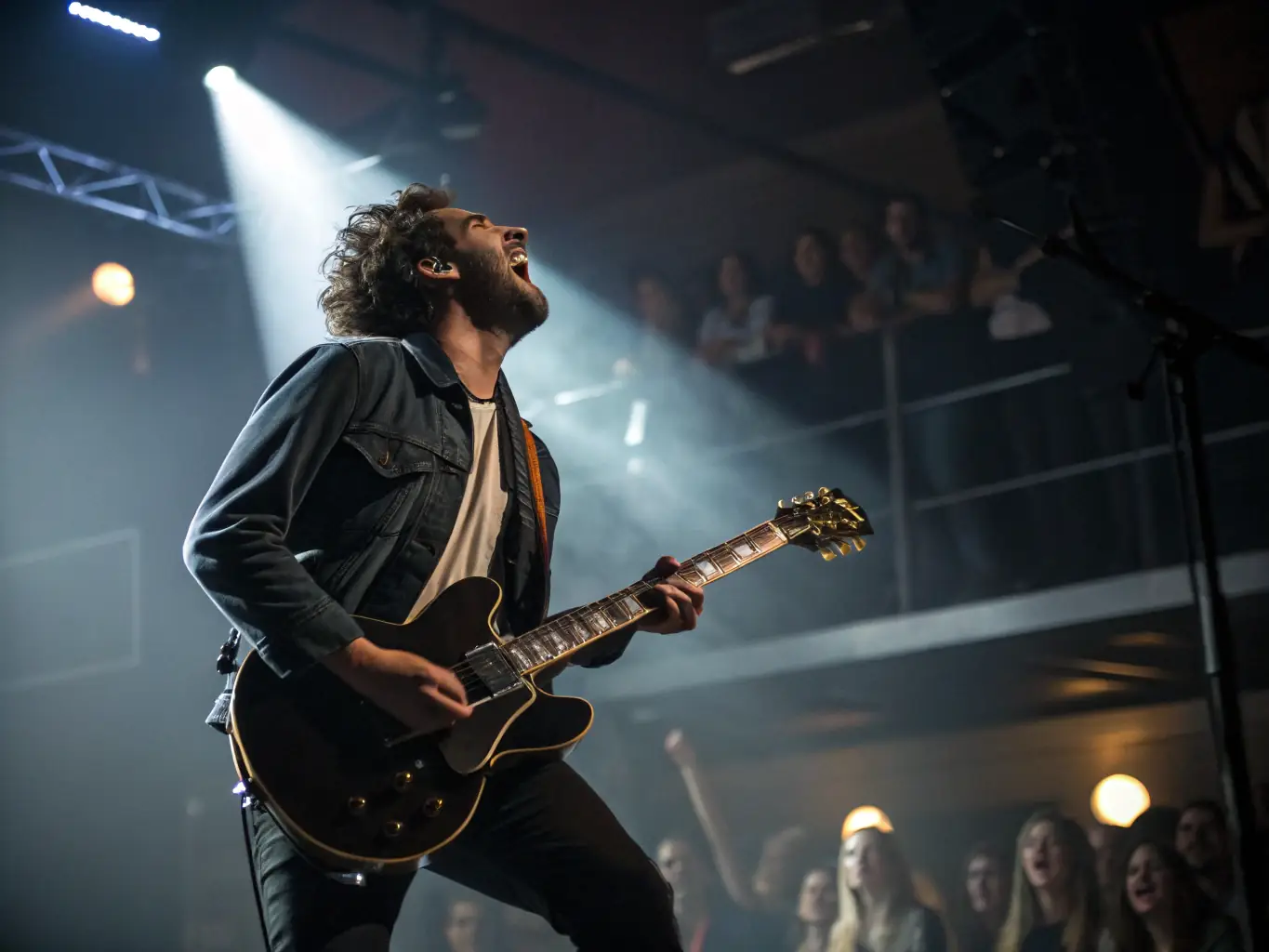 A photograph of a live performance featuring regional artists on stage, with an enthusiastic audience in the background, highlighting the organization's support for local talent.